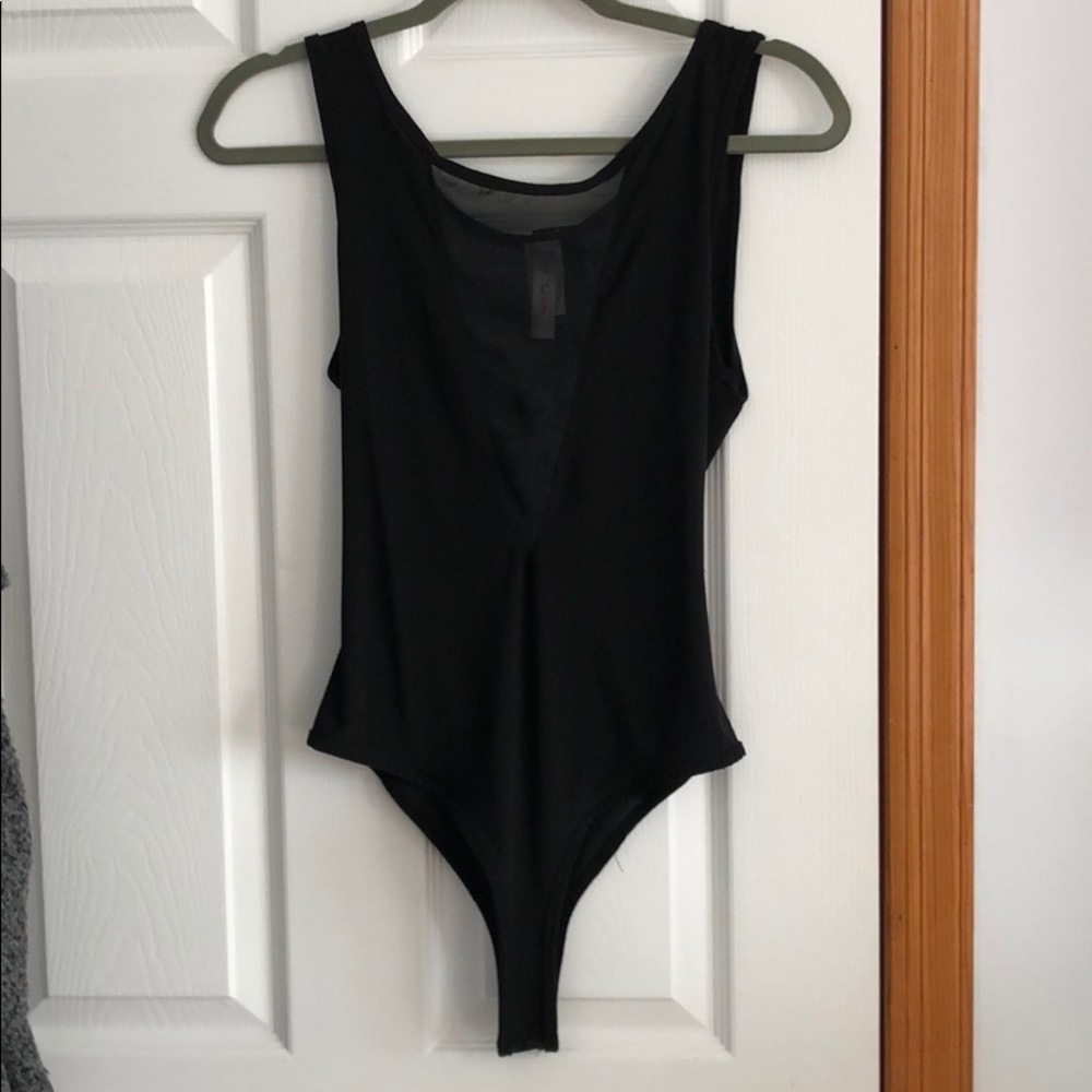 Deep V black body suit.